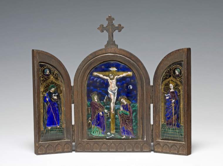 An image of Limoges Painted EnamelCrucifixion with St James and St CatherineCopper, decorated in translucent and opaque enamels, partly over foils. The Crucifixion in the centre panel with St James on the left wing and St Catherine on the right wing.Three copper plaques, almost flat, and partly foiled in silver, enamelled in translucent royal blue, two shades of green, and mulberry, and opaque flesh, red, white, and black,and gilded.       The central arched plaque is decorated with the Crucifixion. Christ hangs on a gold tau cross with the word INRI on a label above his head. He wears a crown of thorns and a loin cloth and blood streams from a wound in his right side. The Virgin Mary stands on the left with her hands extended, wearing a green veil,  a royal blue gown over a green skirt, and a mulberry cloak. St John stands on the right with his hands clasped in prayer, wearing a blue gown with green sleeves, and a mulberry cloak. The blue background is scattered with small groups of gold rays of light, and on the right is a white crescent moon enclosing a profile face. The left panel is decorated with St James standing within an archway on a green tiled floor. He holds a staff in his right hand and an open book in his left, and wears a green hat, blue gown, and a blue-black cloak. Above the arch is a circular medallion of a bearded man in profile to right wearing a green helmet. The right panel is decorated with St Catherine stands on a green tiled floor  in an archway, holding the hilt of a sword in her right hand, and an open book in her left. She wears a gold crown, a mulberry gown and a royal blue cloak. Above the arch is a circular medallion of a clean-shaven man three-quarters to left. The outlines of the costume, the architecture, and medallions are gilded, and their are gold foliated scrolls in the spaces around the medallions. The panels are enclosed in a hinged wooden frame with a wooden cross at the centre over Christ. The lower edge of the interior is decorated 