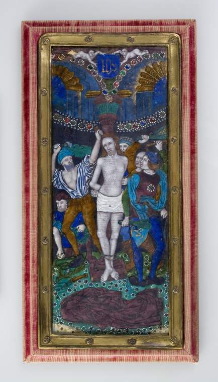 An image of The FlagellationCopper decorated polychrome enamels, jewelling, and gildingRectangular copper plaque with drawing in black over a white ground covered with translucent blue, turquoise, green, tan, and mulberry enamels, opaque red, white, and black enamels, blue, red, and green enamel jewelling over foils, and gilding. The counter enamel is not visible.                                                Christ stands in the centre tied with his arms behind his back to a mulberry column. He is naked except for a white loin cloth and his arms, torso and legs are covered with horizontal lines of drops of blood. His mulberry-coloured cloak lies in the foreground on greensward scattered with numerous flowers with red and green jewelled centres and white dotted petals. Two men on the right and one on the left stand with their arms raised holding bunches of green twigs with which they are about to strike Christ. Another man kneels on the left holding a snaking cord in his right hand and a crown of thorns in his left. The head of another is visible behind the column. Above the figure there is a black drape bordered by a curved line of red, blue and green jewels with white dotted edges. Above it, two flutted arches with jewelled edges spring from the green capital of the column. In the spandrel between them is a green mask, and a blue shield bearing the mnogram IHS in gothic letters, held up by two putti who lie horizontally on the top of the arches. Remnants of lavish gilding are visible on the figures and arches. The narrow gilt-metal inner frame has eighteen flower headed rivets. The outer frame of the stand is covered in very worn crimson velvet and is backed by crimson damask with a hinged prop in the middle.Limoges, FranceC.1520
