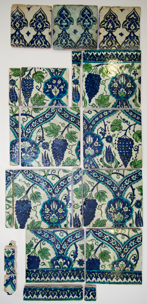 An image of Fritware (stonepaste) tile panel. Islamic pottery; Iznik style. Pale buff frit body painted in blue, green and turquoise-blue, outlined in black, under a clear glaze. Height, whole, 126.5 cm, width, whole, 59 cm, depth, whole, 2.5 cm, average. Ottoman, circa 1560-1600. Syria, Damascus.