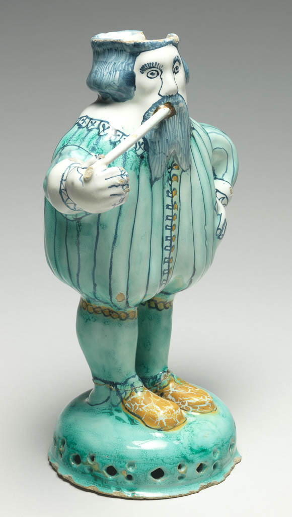 An image of Figure of Nobody. Brislington Pottery, possibly, London. Buff earthenware, moulded in parts, tin-glazed, and painted in blue, pale turquoise-green, yellow, and orange, height, whole, 23.3 cm, diameter, base, 10.6 cm, dated 1675. Anthropomorphic vessel.