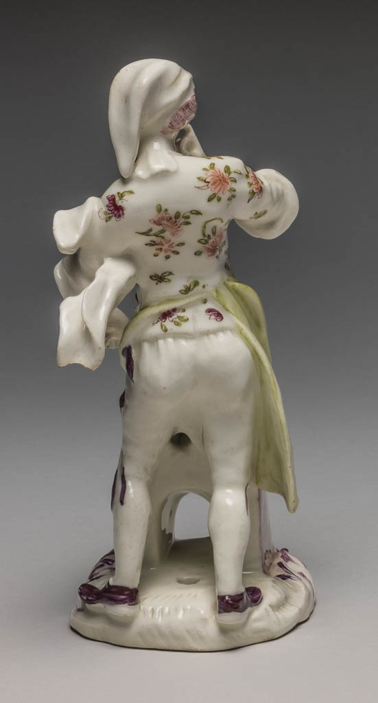An image of Street Cook standing beside Stove. Bow Porcelain Manufactory, Essex. Kaendler, Johann Joachim, modeller, derived from (German, 1706-1775). Reinicke, Peter, modeller, derived from (German, 1715-1768). Huet, Christophe, after (French, op.1735-m.1759). Soft-paste porcelain containing bone ash, press-moulded, and painted overglaze in polychrome enamels, height, whole, 15.6 cm, depth, base, 7.0 cm, front to back, circa 1756-1760. Rococo. Production Note: This cook was copied from a Meissen model by Peter Reinicke after one of a series of coloured drawings of the 'Cries of Paris' commissioned by J.J. Kaendler from the French artist, Christophe Huet (1700-59), and executed in 1753.