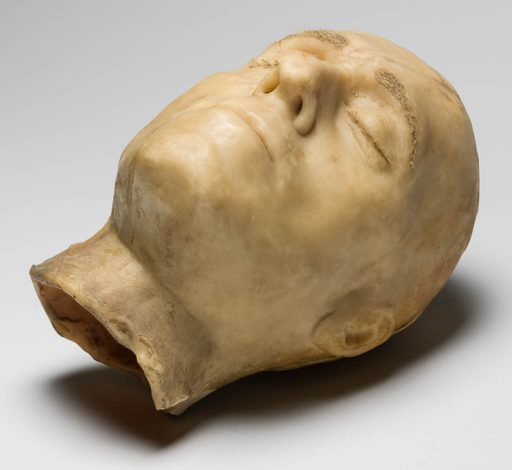 An image of Sculpture. Head of Charles Talbot (1660-1718), Earl of Shrewsbury (1668), Duke of Shrewsbury (1694). Head, wax, cast, with applied hair eyebrows. In later wooden case with convex glass front. Height, whole, 26.0 cm, width, whole, 17.0 cm, depth, whole, 21.5 cm, circa 1718. Production Note: Possibly a model for a funeral effigy, or the head from a funeral effigy. English.