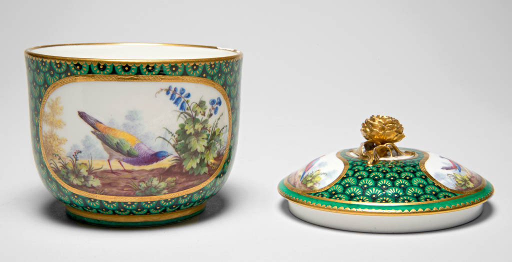 An image of Sugar Bowl and Cover. Pot à sucre Calabre. Aloncle, François-Joseph (painter, French, act.1758-1781). Sèvres Porcelain Manufactory. Painted in enamels in reserves each containing a bird in landscape, and gilded. Soft-paste porcelain, thrown and moulded, decorated with a green ground, painting in blue, very dark blue, shades of green, yellow, pink, red, pale purple, grey, brown, and black enamels, and gilding, height, whole, 10.2 cm (incl. cover), diameter, bowl, 8.9 cm, diameter, cover, 9.1 cm.  The basin bears the date letter for 1769 but decoration was probably added later. Rococo.