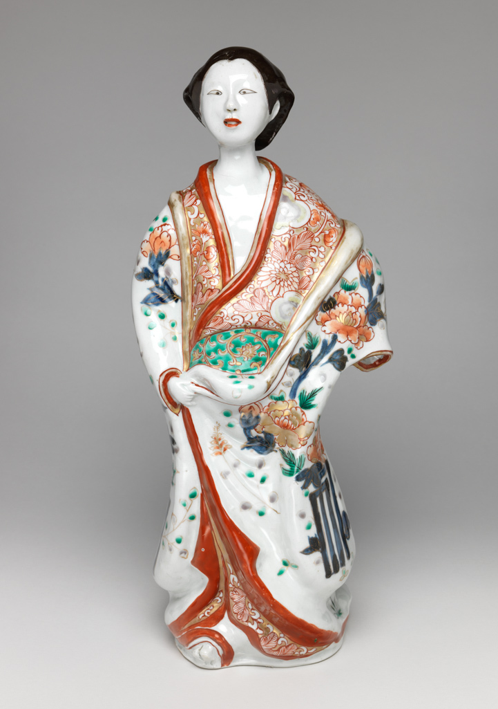 An image of Figure of a female Geisha. Japanese. Imari. Decorated in red, green, blue and black enamels. 1710-1770. Edo Period (1615-1868). Acquisition Credit: Given by David Hyatt King, through The Art Fund.