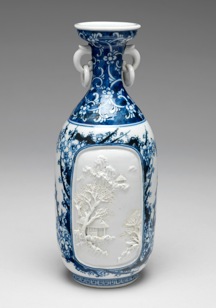 An image of Vase. Unknown maker. Blue and white hard paste porcelain vase with ring handles. Decorated with white high relief late Qing-style landscape. 1870. Meiji Period (1868-1912). Chinese. Acquisition Credit: Given by David Hyatt King, through The Art Fund.