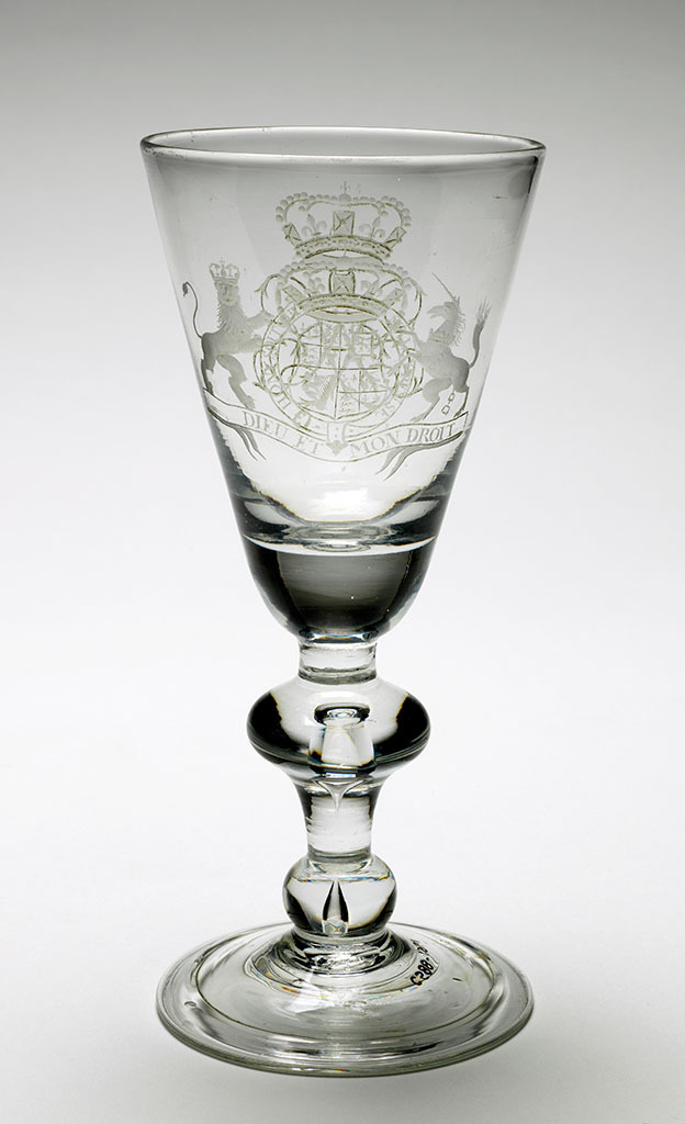 An image of Unknown. Glass Goblet. Round-funnel bowl with solid base engraved on one side with Royal Arms before 1707; on the other side a monogram (?) on cusp-knopped baluster stem. Folded foot. Bowl blown, with engraved decoration, height 20.1cm, diameter (whole) 9.2cm, circa 1700.