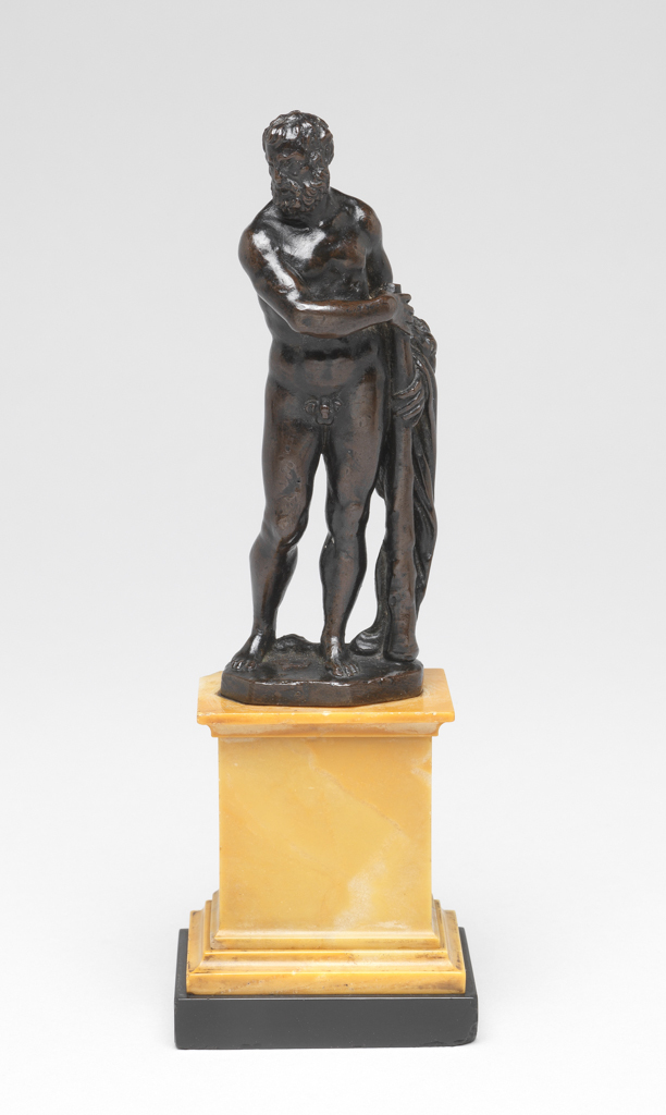 An image of Sculpture/figure. Hercules, bearded and nude, stands in contraposto, his long club held by both hands is upright at his left side. Over left forearm is hung his lion's mane. His is turned to the left, looking down slightly. Bronze, cast, with dark brown patina; highly polished; mounted on a yellow-green marble plinth, height, bronze, 10.6 cm, circa 1460-1500. Notes: The first labour of Hercules was to strangle the invulnerable Nemean Lion, whose skin Hercules wore afterwards as a talisman. Italian.