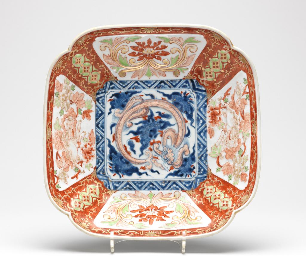 An image of Dish. Moulded square hard paste porcelain dish. Decorated with lions and floral patterns in red, green and underglaze blue enamels, and gilt. 1735-1765. Edo Period (1615-1868). Acquisition Credit: Given by David Hyatt King, through The Art Fund. 