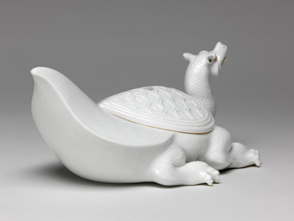 An image of Flaming tortoise, white Hirado. An immortal is missing from the lid. Unknown maker. Hard-paste porcelain, 1750-1780. Edo Period (1615-1868). Acquisition Credit: Given by David Hyatt King, through The Art Fund.