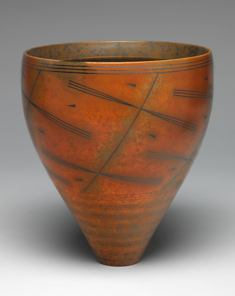 An image of Contemporary Craft. Studio Ceramics. Bowl on Narrow Base. Ross, Duncan (British, b. 1943 India). Circular, standing on a narrow base. The sides slope upwards and outwards to the widest point, and then curve inwards slightly towards the rim. The orange, mottled exterior is decorated round the lower part with pairs of grey broken circles, above which is an abstract design of slanting crosses with pointed triangles in the spaces. There are three dark grey bands round the rim. The interior is mottled in black, grey, and orange. Red earthenware, thrown, coated with terra sigillata slip, decorated with a linear design, burnished, bisque-fired, and smoke fired. Height, whole, 20.5 cm, width, whole, 18.2 cm, 1997. Gift of Nicholas and Judith Goodison through the National Art Collections Fund.