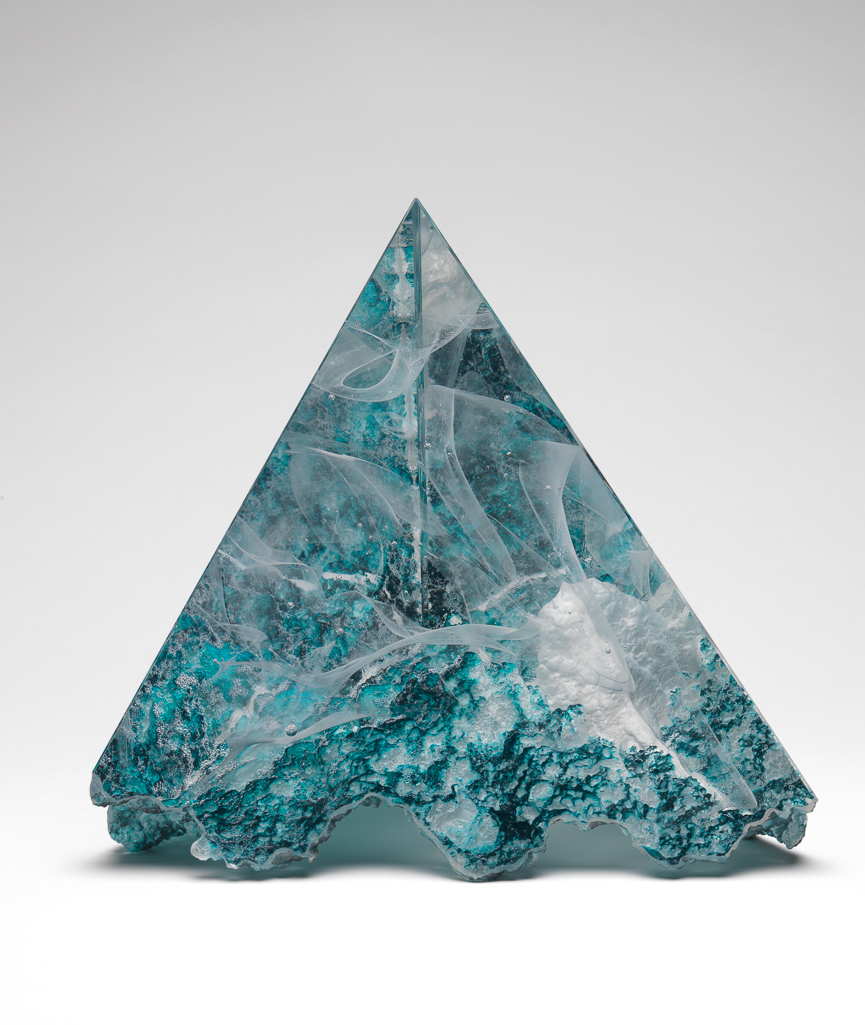 An image of Studio Glass. Pyramid Form. Reid, Colin (British, b.1953). Clear, lost-wax cast glass, with white inclusions, the base partly coloured Prussian blue. Height, whole, 20.5 cm, width, whole, 24.5 cm, 1997. Given by Nicholas and Judith Goodison through the National Art Collections Fund.