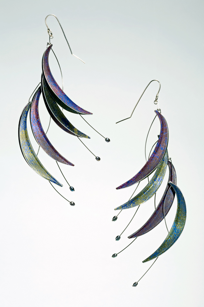 An image of Contemporary Craft/Jewellery. Pair of earings. Adam, Jane (British, b. 1954). Anodised, dyed, and crazed aluminium leaves attached to stainless steel wire, on silver hooks, height, A, 12 cm, height, B, 13 cm, 2008. Notes: See matching necklace M.7-2008. Gift of Nicholas and Judith Goodison through The Art Fund.