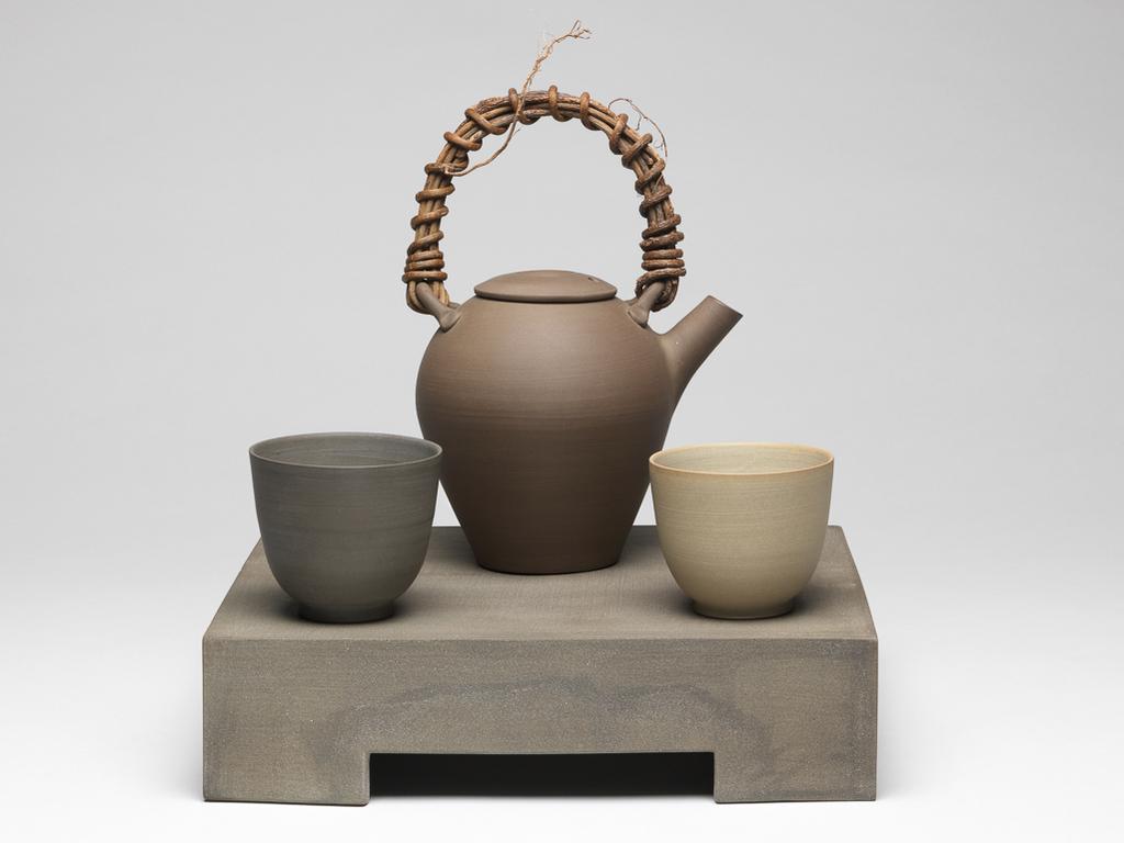 An image of Contemporary Craft. Studio Ceramics. Tea set with two cups (C.22.2 & 3-2002), a tea pot (C.22.1&A-2002), and a ground (tray, C.22.4-2002). Stair, Julian (British, b.1955). 2002. Given by Nicholas and Judith Goodison through the National Art Collections Fund.