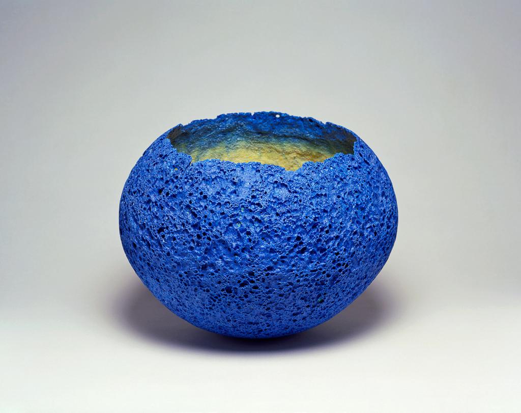 An image of Studio Glass. Sphere. O'Dare, Emma (British, b. 1972). Royal-blue volcanic pâte-de-verre with yellow ochre interior shading to blue at the top. Three-quarters of a sphere with an irregular rim. Height, whole, 27.2 cm, diameter, whole, 36.5 cm, circa 1999. Gift of Nicholas and Judith Goodison through the National Art Collections Fund.