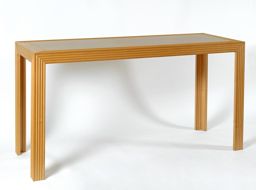 An image of Furniture. Contemporary Craft. Console table. Peters, Alan, OBE (British, 1933-2009). Sycamore decorated with fluting. The rectangular top has a narrow border, the apron is fluted horizontally, and the rectangular legs vertically fluted on the outside edges. Height 87.8 cm, length 167.8 cm, depth 61 cm, 1990. Given by Nicholas and Judith Goodison through the National Art Collections Fund.