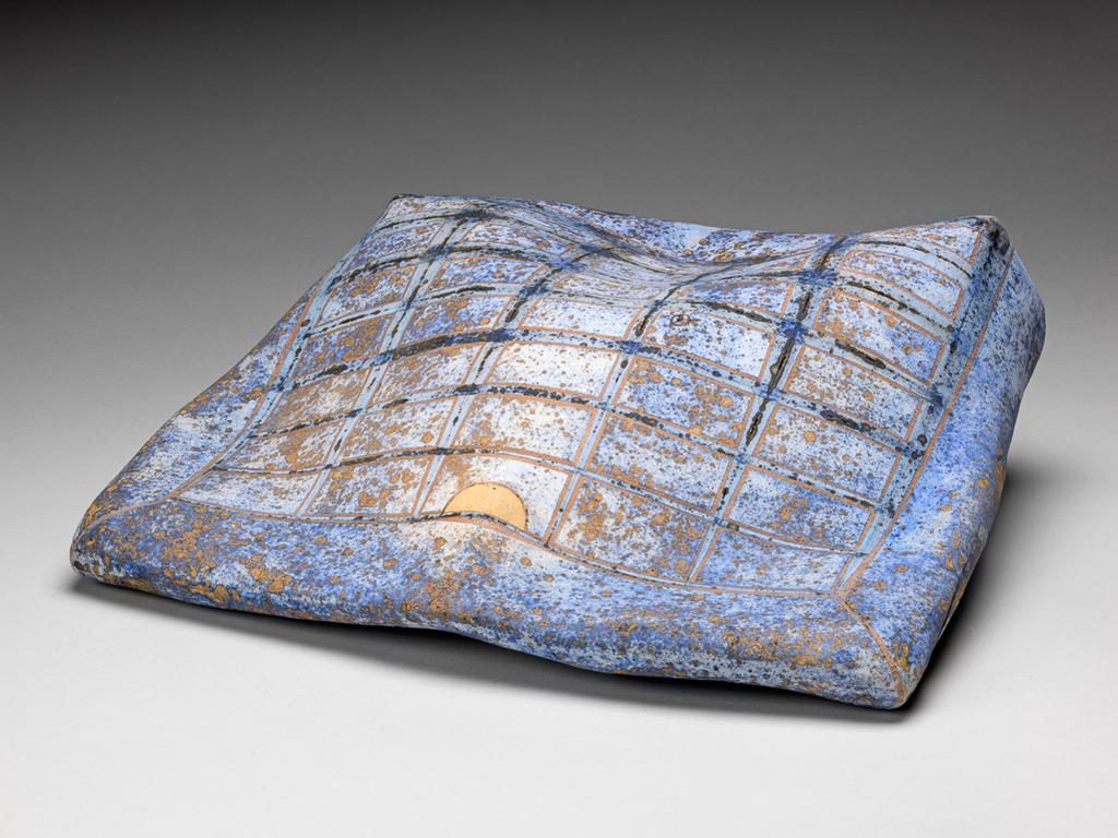 An image of Studio Ceramics. Going Down Slow. Heinz, Regina (b. Austria 1957). Bag-shaped ceramic form, stoneware decorated with lithium glaze, coloured slips and oxides with a grid pattern. Stoneware, hand-built, squashed, fired to biscuit, and decorated with lithium glaze, coloured slips and oxides. 2002. Gift of Nicholas and Judith Goodison through the National Art Collections Fund.