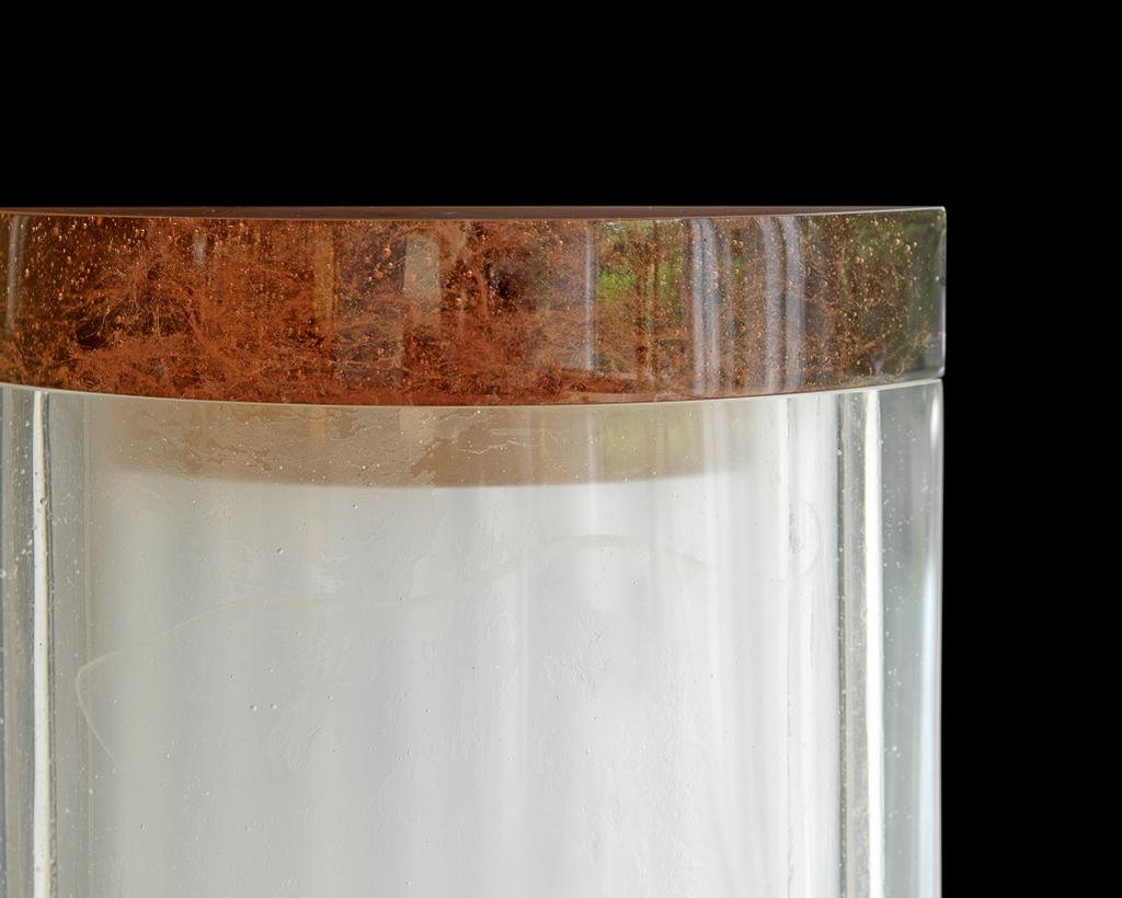 An image of Studio Glass. Glass Art. Doric. Clegg, Tessa ( b. 1946). Cast clear glass with a lid cast in cloudy yellow-green dichroic glass (A). Cast clear bubbly glass with a cast lid of yellow-green dichroic glass. Of shallow D-shaped plan. Height, whole, 36 cm, width, across back, 23 cm, depth, centre front-back, 7 cm, circa 2005. Gift of Nicholas and Judith Goodison through the National Art Collections Fund.