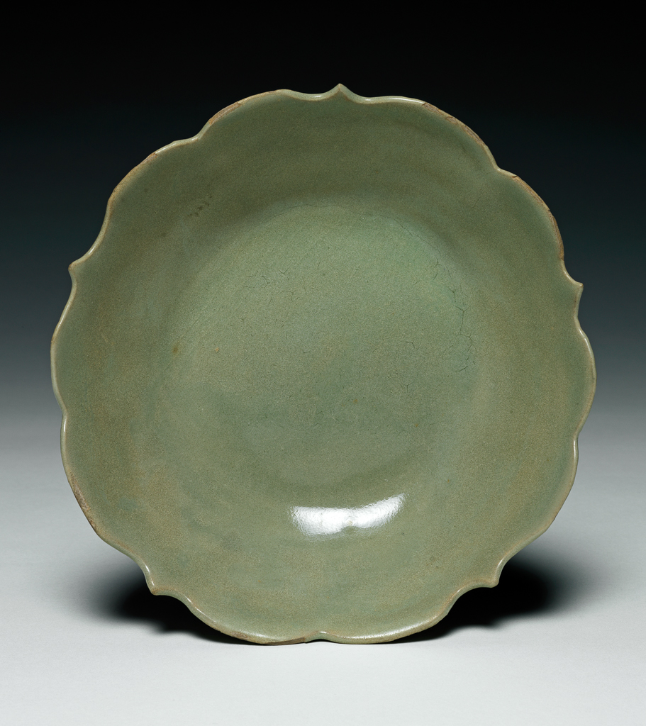 An image of Stoneware dish with a foliate edge. Yue ware. Diameter 15.6 cm. T’ang Dynasty (618-906). Chinese.