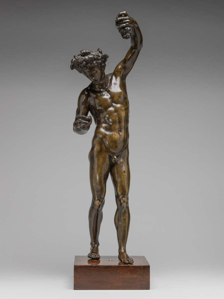 An image of Bacchus. Sculpture/figure. van Tetrode, Willem Danielsz, sculptor (b. Delft 1525; d. Arnsberg 1580, Rome, possibly). Bacchus stands with his left leg placed in front of the right. His left arm is raised and holds a bunch of grapes. His head is bent and turned to the left as he gazes down at his right hand, which once seems to have held a cup. His hair is entwined with vines. Copper alloy, probably bronze, cast, and polished, height, whole, 50.5 cm, width, whole, 15.5 cm, depth, whole, 17.0 cm, circa 1570-1575. Renaissance. Production Note: Previously attributed by Anthony Radcliffe to Hubert Gerhard. The bronze has been attributed to Tetrode working in Rome or in Delft after his return there.