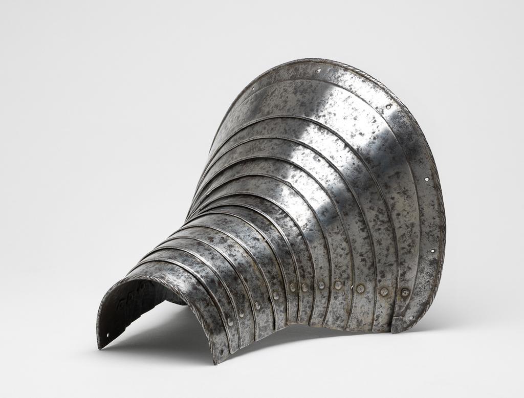 An image of Armour. Leg-defence for the right foreleg of a horse. Unknown production, Germany. Formed of twelve downward-overlapping lames curved to the front of the horse's upper foreleg and shoulder, and increasing in width to its upper end. The upper edge of the top lame is slightly convex with gently rounded corners. It has a file-roped inward turn accompanied by a recessed border containing nine holes for lining-rivets, all of which are now missing. The lower edge of the bottom lame also has a file-roped inward turn. The outer ends of the lame are each pierced with a rivet-hole that formerly served to secure a strap around the rear of the horse's leg. The first to eleventh lames have bevelled lower edges. The lames are connected to one another at their outer ends by modern, round-headed lining-rivets with internal washers that are variously square, pentagonal, hexagonal or circular. The lames were further connected to one another by a pair of internal leathers located a short distance within the sliding-rivets. The leathers were attached to each lame by single externally-flush rivets, all of which are now missing. Steel, formed of twelve downward-overlapping lames curved to the front of the horse's upper foreleg and shoulder, and increasing in width to its upper end; hammered, shaped, riveted, with a recessed border, file-roped and bevelled decoration. Height, whole, 25.6 cm, maximum, width, whole, 26.2 cm, maximum, depth, whole, 22.1 cm, maximum, weight, whole, 1.07 kg, circa 1550. Provenance: From the armoury of the Princes Radziwill, Castle of Niescwiez, Poland. Production Notes: The leg-defence originally had a `black from the hammer' finish, now cleaned to a mottled bright finish with light to heavy pitting overall. Similar leg-defences for a horse are depicted in Hans Burkmeier's Triumph of Maximilian. Forming a pair or near pair to M.9-1945.