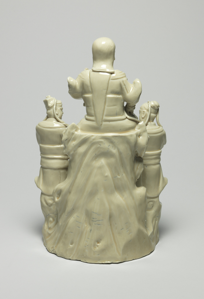An image of Zhenwa group. Seated Zhenwa with standing military acolytes, a tortoise and snake below on complicated rockwork base. Blanc de Chine. 1575-1599. Chinese.