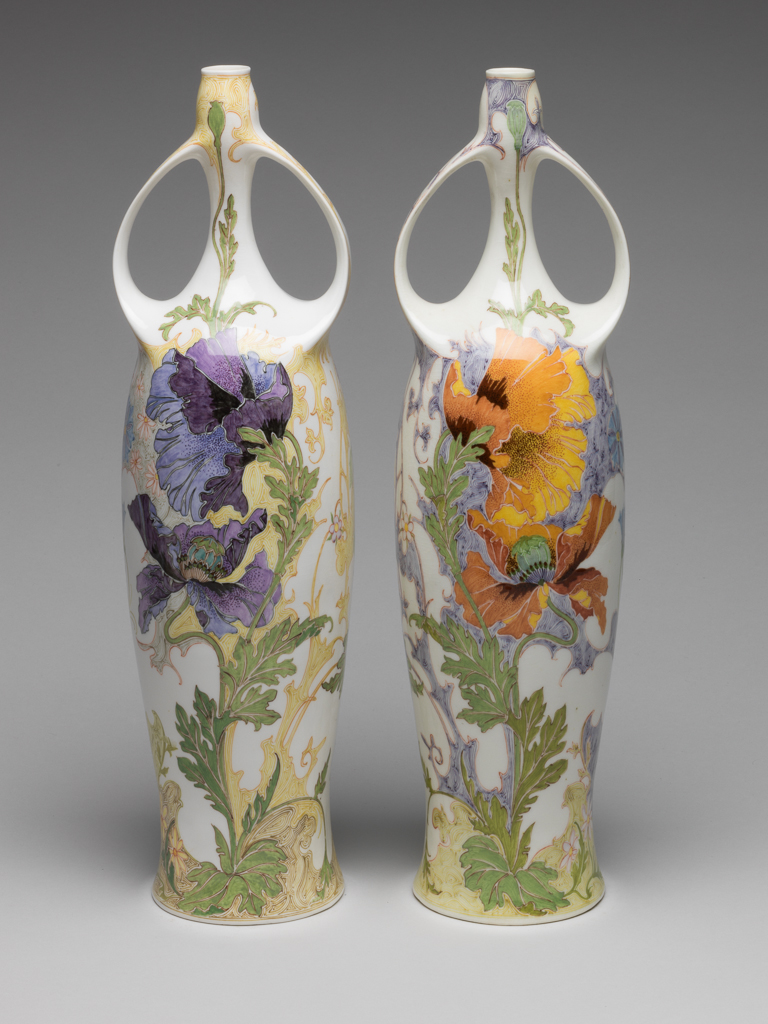 An image of Pair of two-handled balaster vases. Tegel en Fayencefabriek Amphora Factory, Oegstgeest. Designed by J. Jurriaan Kok (Dutch, 1861-1919). Painted by Samuel Schellink (Danish, 1876–1958). C.28-2014: Tall eggshell porcelain vase, baluster shape, hand-painted in polychrome enamels with bird, poppy and foliage motifs in Art Nouveau style. Circular in plan, with tall gently-concave body rising to a long narrow neck, the top of the neck slightly wider than the bottom. Two strap handles, cast with the body, rise from the shoulders and rejoin the vase towards the top of the neck. The overall form suggests an erect female body with arms raised to her head. Decorated with a finely painted flowing floral design. On one side is a green-headed songbird which appears to be flying out of the body. On the other side is a large spray of purple and light blue oriental poppies. Eggshell porcelain, decorated underglaze in polychrome enamels with hand-painted motifs, height 36.5 cm, base width 8.5 cm, circa 1914.C.29-2014: Tall eggshell porcelain vase, baluster shape, hand-painted in polychrome enamels with bird, poppy and foliage motifs in Art Nouveau style. Circular in plan, with tall gently-concave body rising to a long narrow neck, the top of the neck slightly wider than the bottom. Two strap handles, cast with the body, rise from the shoulders and rejoin the vase towards the top of the neck. The overall form suggests an erect female body with arms raised to her head. Decorated with a finely painted flowing floral design. On one side is a black-headed songbird which appears to be flying out of the body. On other side is a large spray of orange oriental poppies. Eggshell porcelain, decorated underglaze in polychrome enamels with hand-painted motifs, height 36.5 cm, base width 8.5 cm, circa 1914.