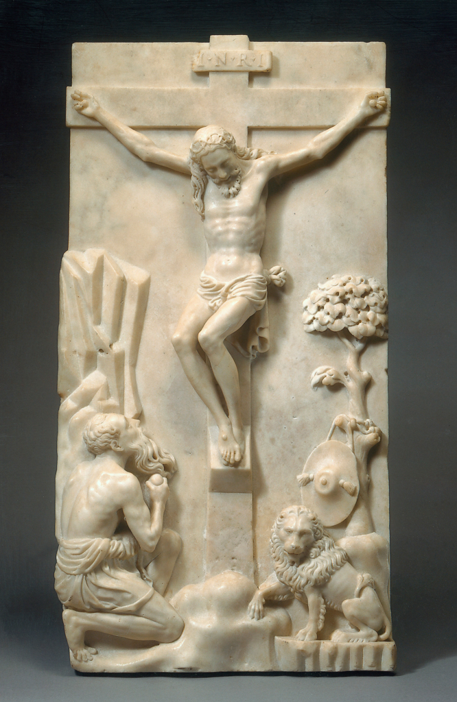 An image of Christ on the cross mourned by St Jerome. Ferrucci, Andrea (Italian, 1465-1526). Rectangular white marble panel carved in high relief with St Jerome kneeling on the left beside a rock, Christ on the Cross in the centre, and a lion on the right with a cardinal's hat hanging from a stylized tree above. White marble, carved in high relief, height 61 cm, width 30.5 cm, c.1500. Florence, Italy.