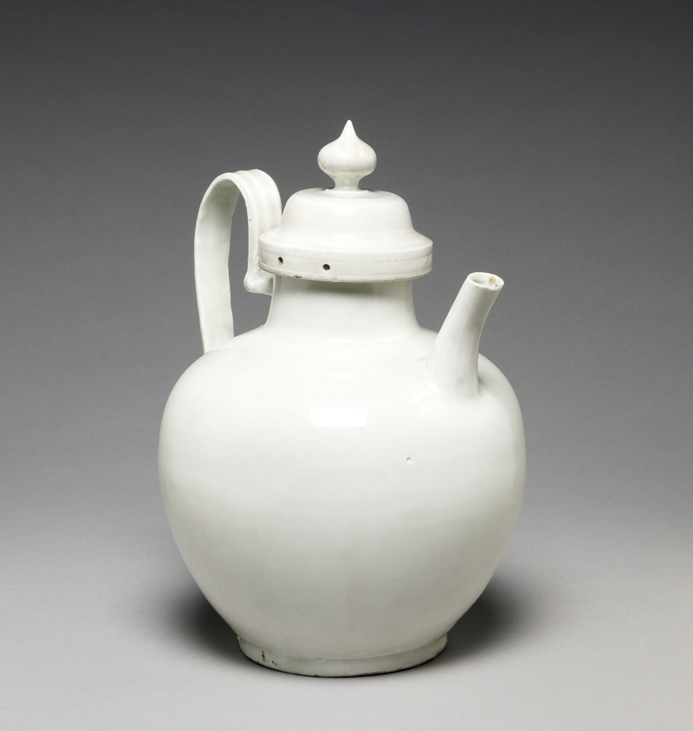 An image of Ewer. Drinking vessel and cover. The handle is long, and the spout is short. Porcelain, white glaze, height 20.3 cm, length 14.3 cm, 1131-1162. Shao Hsing period. Song Dynasty (960-1279). Chinese.