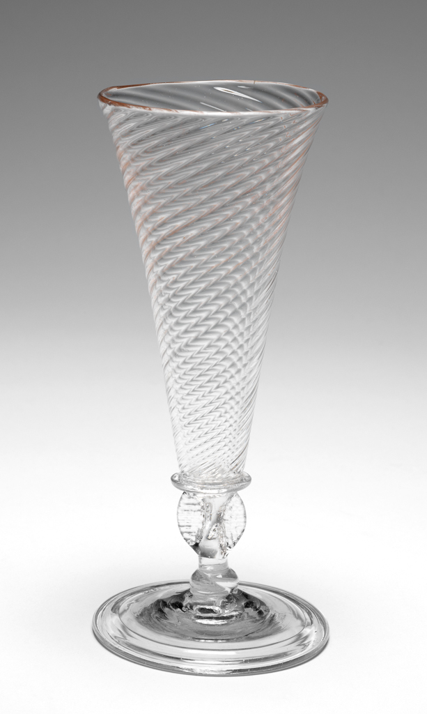 An image of Wine glass/drinking glasses. Unknown English glassmaker. Wrythen funnel shaped bowl, winged stem with knop, folded foot. Uncoloured glass, probably decolourised by addition of manganese. Lead-glass, bowl blown, height, whole, 17.6 cm, circa 1700-1730.