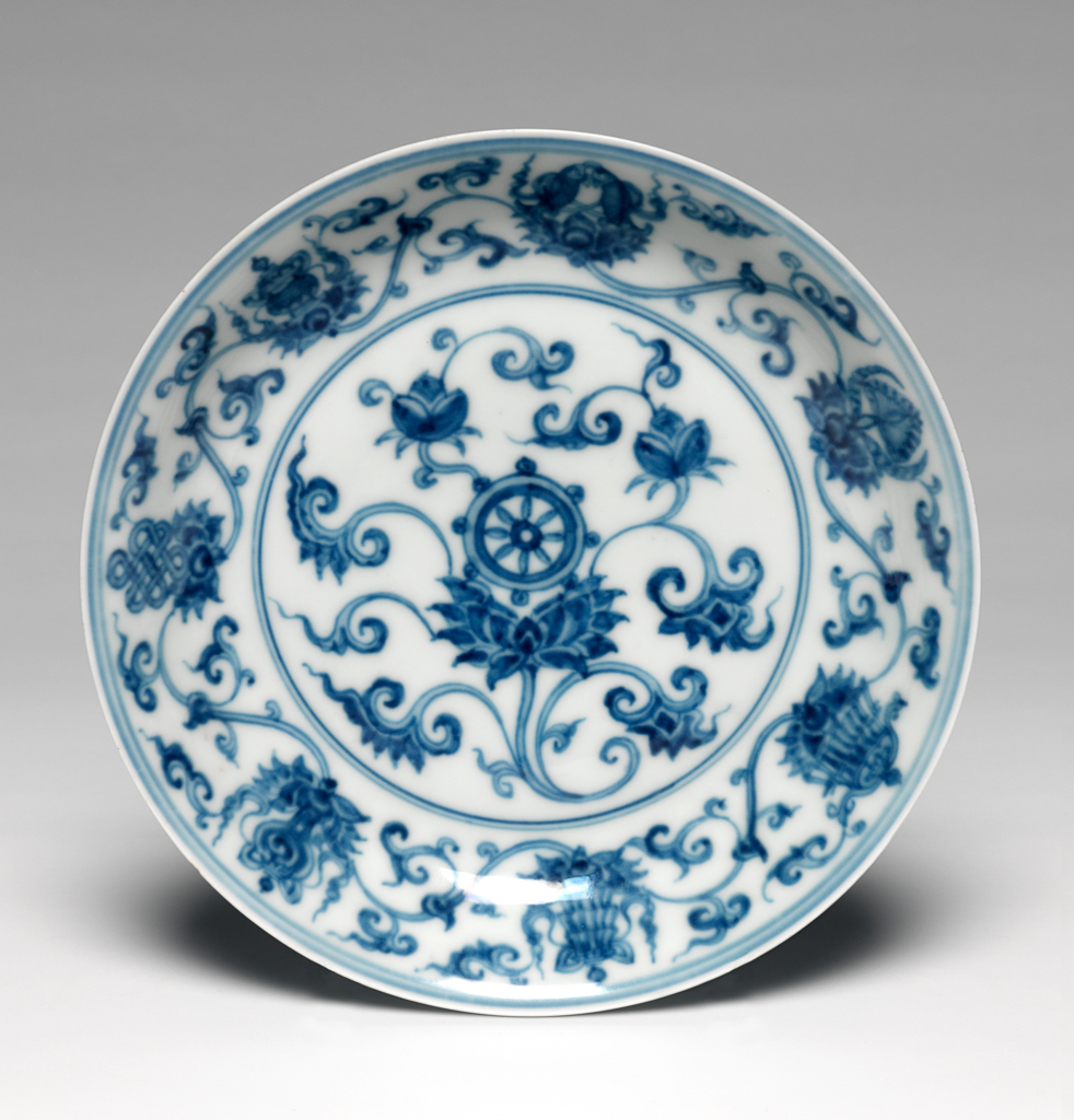 An image of Dish. Saucer dish. The dish is decorated with eight emblems of Buddhism among formalised lotus scrolls. Mark and period of Ch'eng Lua. Production Place: China. Hard-paste porcelain.