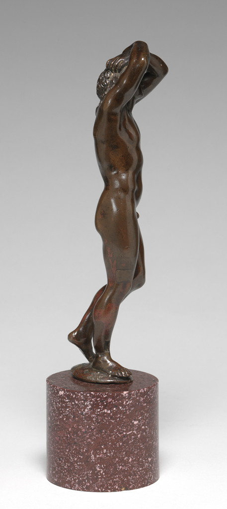 An image of Sculpture / Figure. Standing Youth, known as Narcissus. Prieur, Barthélemy (French, School of, 1536-1611). Copper alloy, probably bronze, cast, patinated, and polished, mounted on a red porphyry pedestal, height, whole, 20.8 cm, circa 1600-1650. Renaissance.