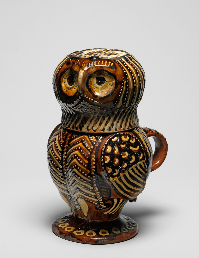 An image of Owl Jug. Lead-glazed earthenware, thrown in two parts, decorated with slip-trailing in two shades of brown and white slip, height 22.4 cm, circa 1680-1700. Staffordshire, England.