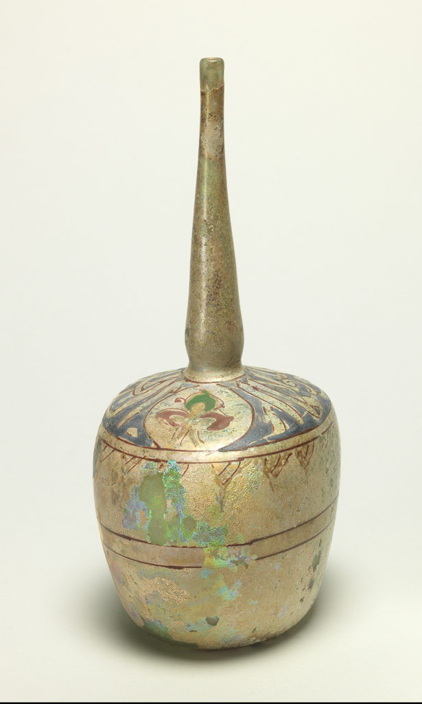 An image of Sprinkler Bottle. Unknown production, Syrian or Egyptian. Enamelled on the shoulder in blue, green, yellow and red with lotus flowers and the inscription 'Glory to our Lord, the Sultan'; traces of two bands of red enamel around the body. Clear blown glass with green tinge, enamelled, height, whole, 28.0 cm, diameter, whole, 11.5 cm, circa 1300-1400.