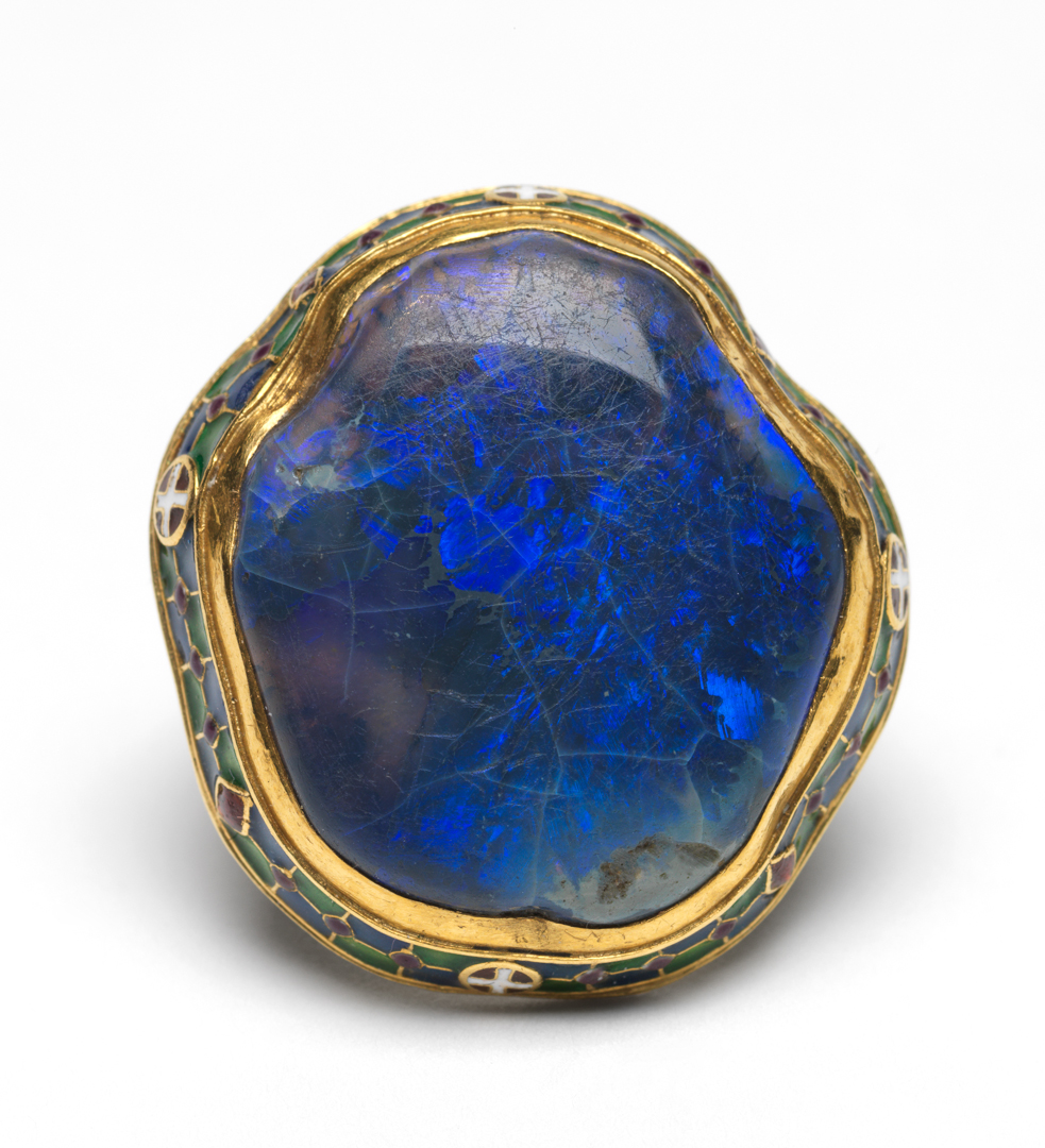 An image of Jewellery. Ring.Wilson, Henry, designer (British, 1864-1934). Gold, set with a black opal, and enamelled round the edge of the bezel and on the shoulders, length, bezel, 3 cm, diameter, whole, 2 cm, early 20th century. London.