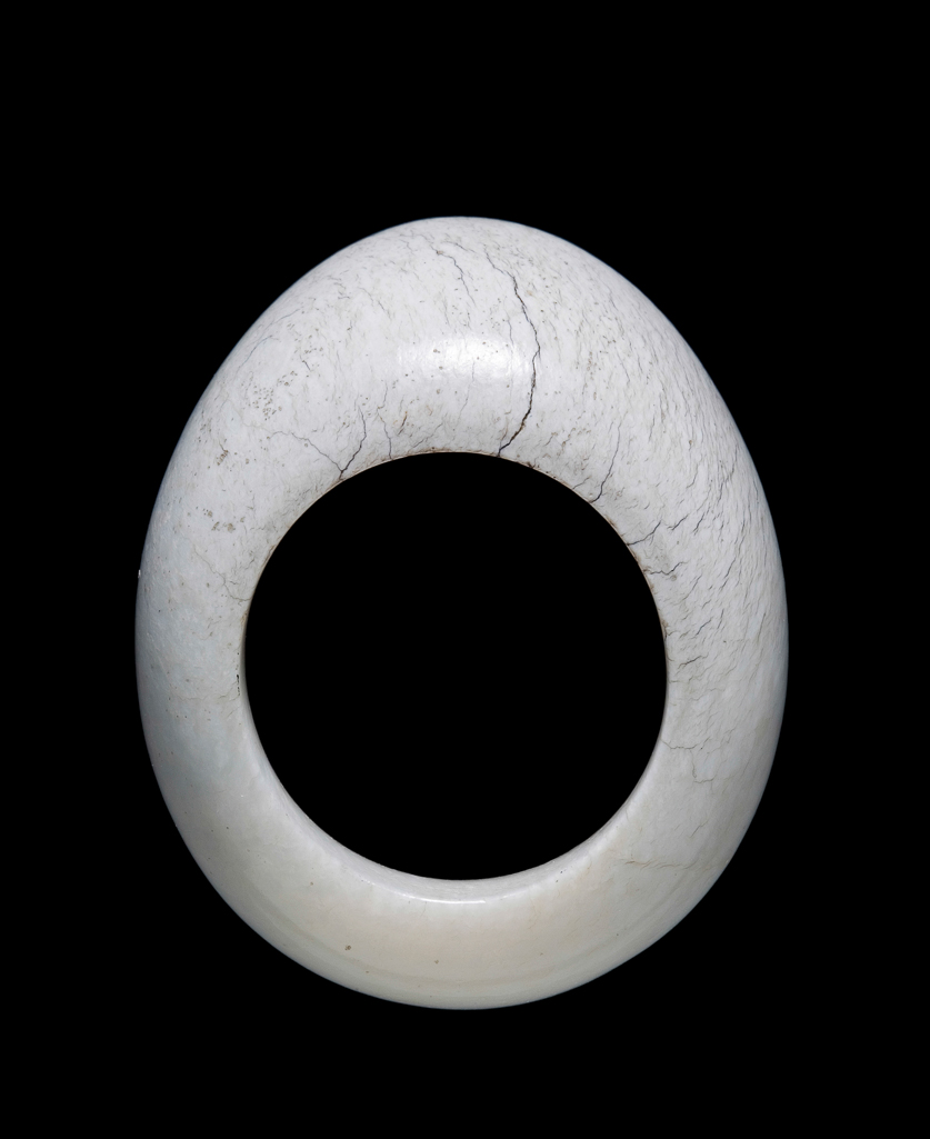An image of Thumb ring. Opaque white jade with plain surface. Nephrite, length 4.2 cm, 1800-1900, Chinese.