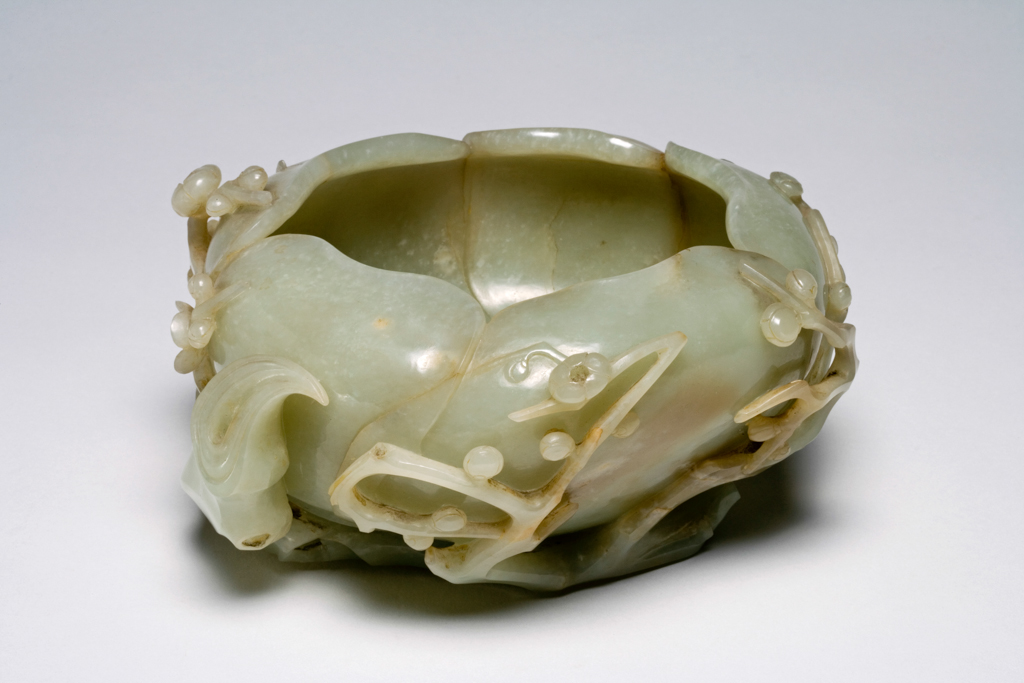 An image of Brush Washer. Opaque celadon jade, well hollowed and carved with gnarled branches of prunus blossoms issuing from underneath a magnolia flower. Nephrite/jade, height 9 cm, length 17 cm, circa 1500-1700. Chinese. Ming Dynasty (1368-1644). Stolen 13 April 2012.