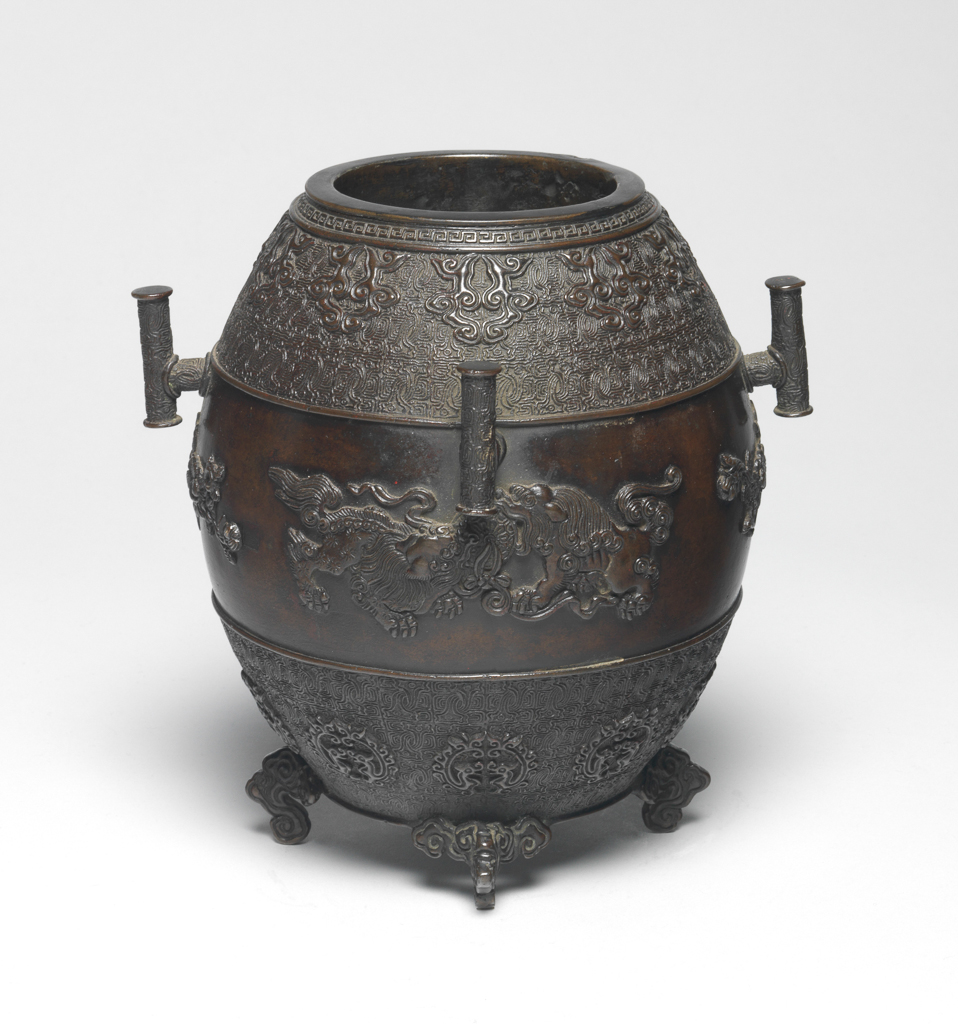 An image of Bronze censer. Seimin, Muraka (Japanese). Moulded, case decorated with two pairs of lions confronting each other on the surface. The censer is inscribed underneath with nine characters. Circa 1818-1829.
