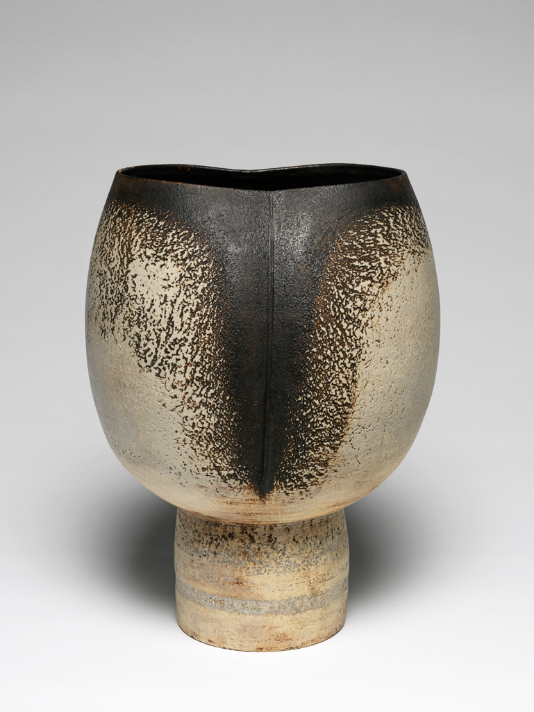 An image of Vase. Coper, Hans (British potter, 1920-1981). Stoneware, thrown in two parts, partially coated with manganese-black slip and abraded, height, whole, 27 cm, width, rim, 16 cm, diameter, base, 10 cm, circa 1966-1970. Studio Ceramics.