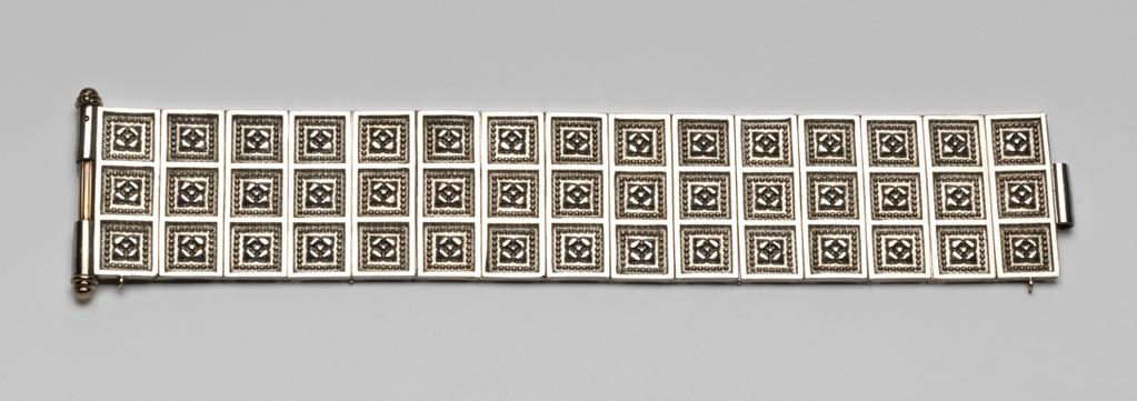 An image of Jewellery. Bracelet. Giuliano, Carlo (Italian, 1831-1895). Composed of cast and chased silver panels hinged together and fastened by means of sliding gold rod which passes through three sections of silver tube, one in the middle of one end of the bracelet and two at the top and bottom end of the other. Each panel is decorated with three sunk squares containing a four-petalled flower surrounded by beading. In maroon leather case (A), lined with red velvet and inside the lid with white silk, printed in gold with a crown and 'C. & A. GIULIANO/115 PICCADILLY/LONDON'. Silver and gold, length, bracelet, 18.0 cm, width, bracelet, 4.0 cm, length, case, 21.5 cm, width, case, 7.2 cm, circa 1874-1895, case c. 1896-1911. Acquisition Credit: Given by Mrs J. Hull Grundy.