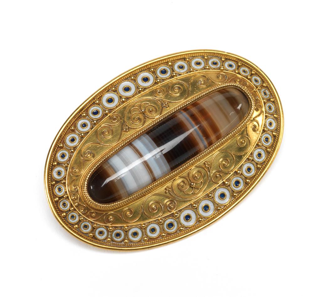 An image of Jewellery. Brooch. Phillips, Robert (British, d.1881). Of slightly convex, oval shield shape with a pin fastening across the back. Inscribed ‘M.P.K/Christmas, 1865’ and 'K.J.K.'. Gold, set with a banded agate and decorated with filigree, granulation, and black and white enamel. Height, whole, 4.8, cm, width, whole, 3.2, cm, dated 1865. Production Note: The brooch may have been a pendant, the present clasp forming the loop at the top. Acquisition Credit: Given by Mrs J. Hull Grundy.