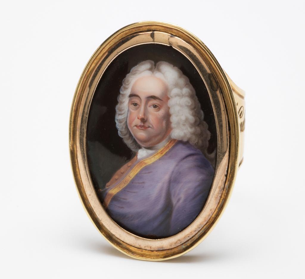 An image of Jewellery. Ring with portrait of George Frideric Handel (1685-1759). Craft, William Hopkins (British, op.1774-, d.1805). Gold, the bezel set with an enamel miniature painting of Handel. The ring band is engraved 'Handel by Zincke from the Lumsden Propert/Sale'; and inside ring, 'Presented to/Dr Whitfield by/Dr Hague, Camb/commencement/July 1819'. Late 18th century. Production Note: The miniature was formerly attributed to Christian Friedrich Zincke. The miniature was taken from the portrait of Handel by Hudson now in the National Portrait Gallery (No. 3970), but the costume was changed.