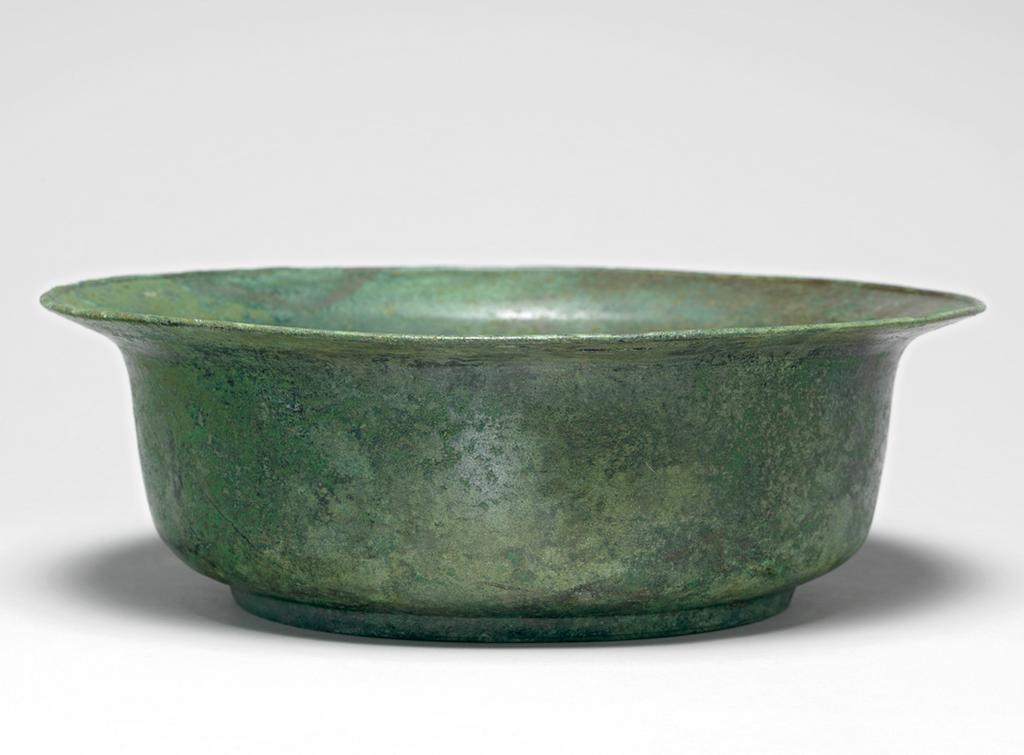 An image of Metalwork/Basin. Unknown Maker. Deep basin with elegantly curved sides and averted rim on shallow foot-ring, of spun bronze, heavily patinated, azurite outside base. AD 1000-1200. Production Place: Korea.