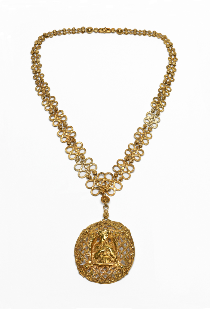 An image of Jewellery. Pendant and chain. Wilson, Henry (British, 1864-1934). The almost circular pendant centred on an angel holding a dove, surrounded by four openwork knots, leaves and berries. The loop for suspension is decorated with a larger circular berry. The chain is composed of openwork figure-of-eight knots of graduated size, separated by pairs of circular berries. On either side of the fastening there is a circular stud. Gold, height, pendant, 6.1 cm, width, pendant, 4.4 cm, length, chain, 42.7 cm, circa 1900-1910. Acquisition Credit: Given by Mrs J. Hull Grundy.