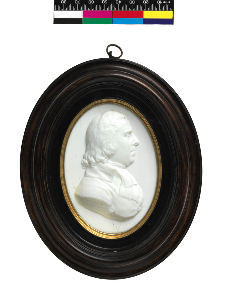 An image of Portrait medallion of James MacLean. Tassie, James (Scottish, 1735-1799). Relief portrait of James MacLean in profile to right on an opaque white background, mounted in an oval, glazed pearwood frame, with a gilt edge next to the medallion, and a gilt-metal suspension ring at the top. Opaque white glass, height, frame, 15.6 cm, width, frame, 12.3 cm, dated 1796. Neoclassical. Sir Ivor and Lady Batchelor Bequest.