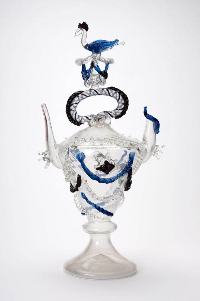 An image of Continental glass. Càntir. Pouring vessel for wine. Façon de Venise. Unknown glasshouse, Spain, Catalonia. With bird finial. Clear and blue glass, blown, height, 44 cm, width, 23.5 cm, after 1650 to before 1800.  Production Note: A càntir is a vessel for pouring water. The word derives from the Spanish cántaro, a ceramic jug. Sir Ivor and Lady Batchelor Bequest through The Art Fund.