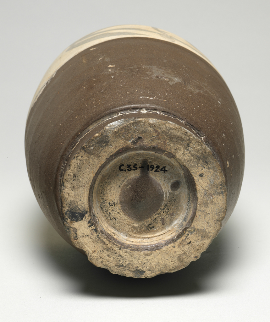 An image of Vase. Cizhou ware/Tzu chou. Unknown production, China. Stoneware vase, with four loop handles. The top part is white over brown scroll decoration, while the lower part is matt brown. Stoneware, height, 30.5, cm, width, 13.3, cm. Song Dynasty (960-1279). Acquisition Credit: Given by Oscar C. Raphael.