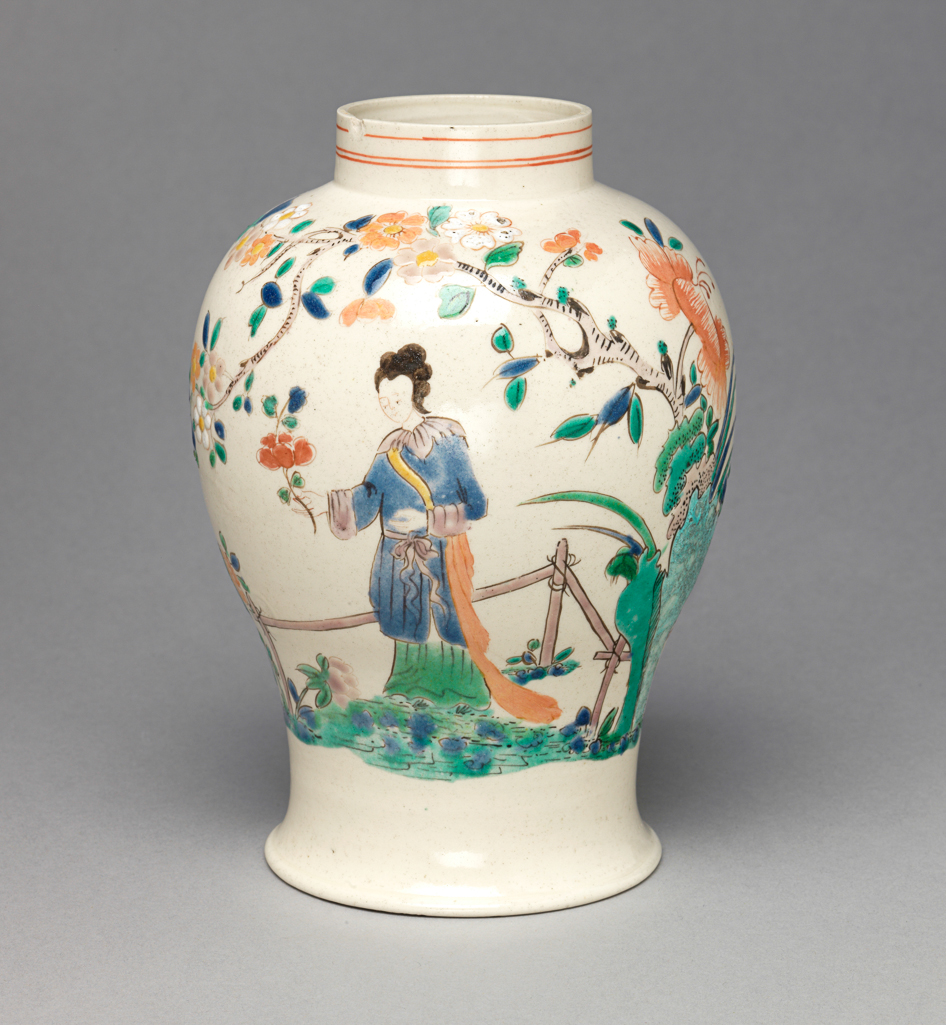 An image of Vase. Unidentified Staffordshire factory, England. Painted in polychrome enamels with Chinese figures in a garden with rocks, a fence, flowering trees and plants. Of squat meiping form with a narrow neck. The sides are decorated with a continuous Chinese garden scene. On one side, a lady stands holding a flower beside a fence with a flowering plant on the left. To her right is a rock formation and a tree with a flowering branch which extends over her. Another flowering branch extends to the right over a seated man and a standing woman. Round the neck there are three narrow red horizontal lines. Off-white stoneware, thrown, salt-glazed, and painted in blue, turquoise, green, yellow, pale salmon-pink, a little red, pale pinkish-purple, and black enamels. Height, whole, 14.7 cm, diameter, whole, 10.5 cm, diameter, foot, 7.8 cm, circa 1755-1760. Rococo. Chinoiserie. Sir Ivor and Lady Batchelor Bequest through The Art Fund.