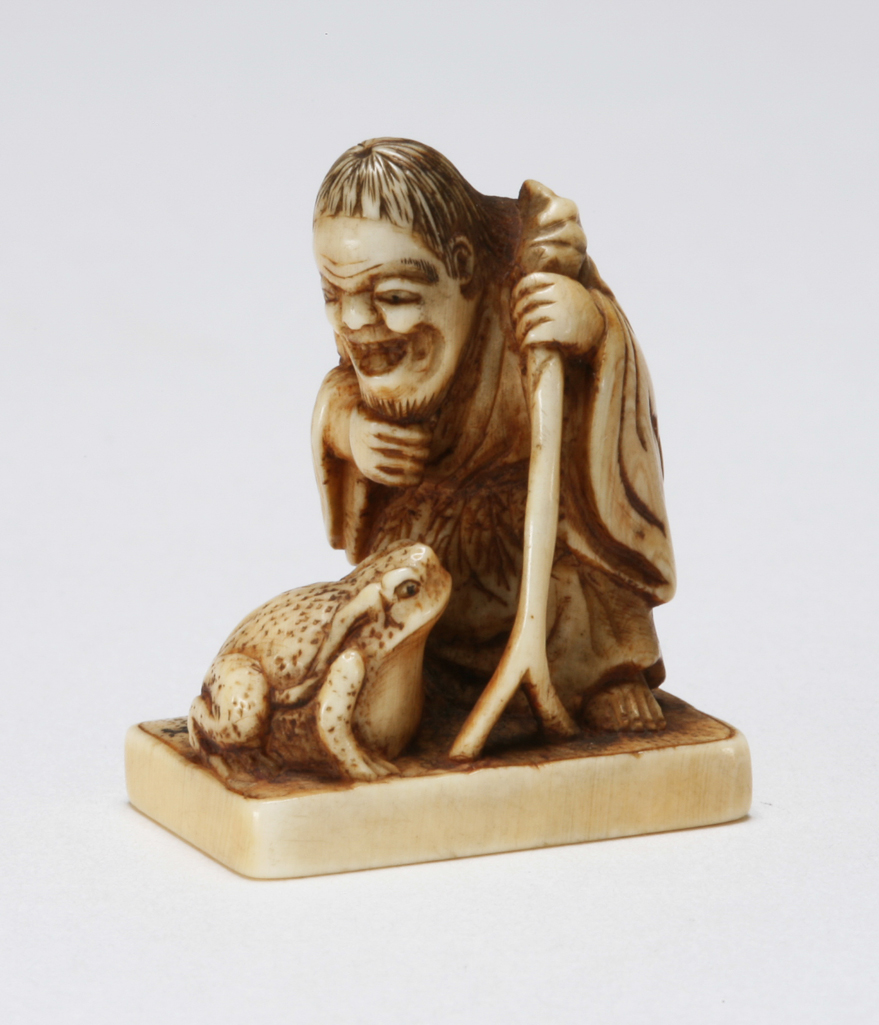 An image of Netsuke. Gama Sennin with his toad and stick. Unknown maker, Japan. Ivory, carved and stained, height 3 cm. Acquisition Credit: Marlay Bequest.