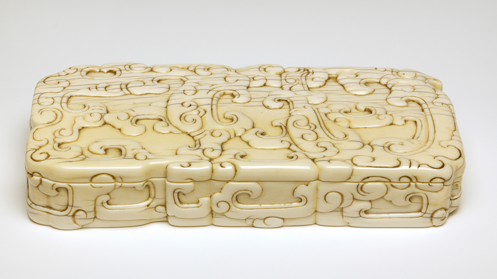 An image of Ink-stone case with sliding lid, ivory carved in low relief on the top and sides with archaistic motifs. Production Place: China. Ivory, carved. 19th century. Sir Victor Sassoon Chinese Ivories Trust.