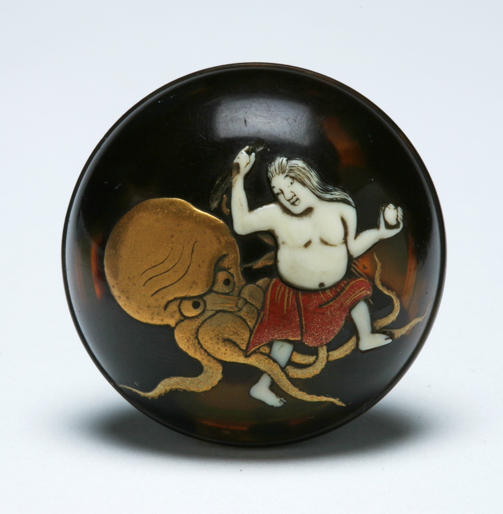 An image of Netsuke: manju: Fishergirl fighting an octopus. Shibayama, c.1870, Japan. The cover is inset with a fishergirl fighting a gold octopus, its tentacles ensnaring the leg of the ivory fishergirl with long black hair and a red lacquer and gilt skirt. Her right arm is raised and clutching a dagger; in her left hand she holds a shell. The base is inlaid in gold with sea plants, a gold shell, and a Shakudo clam, and it has a central himotoshi. Tortoiseshell, ivory, gold and red lacquer, of circular form with an eyelet on the cover, circa 1870. Edo Period (1615-1868). Notes(s): The octopus (tako) is symbolic of prolificacy possibly on account of its many tentacles. It is also a phallic emblem and its supposed infatuation with young girls is the subject of many erotic netsuke. In folklore the octopus acts as physician to Ryujin, the God of the sea.